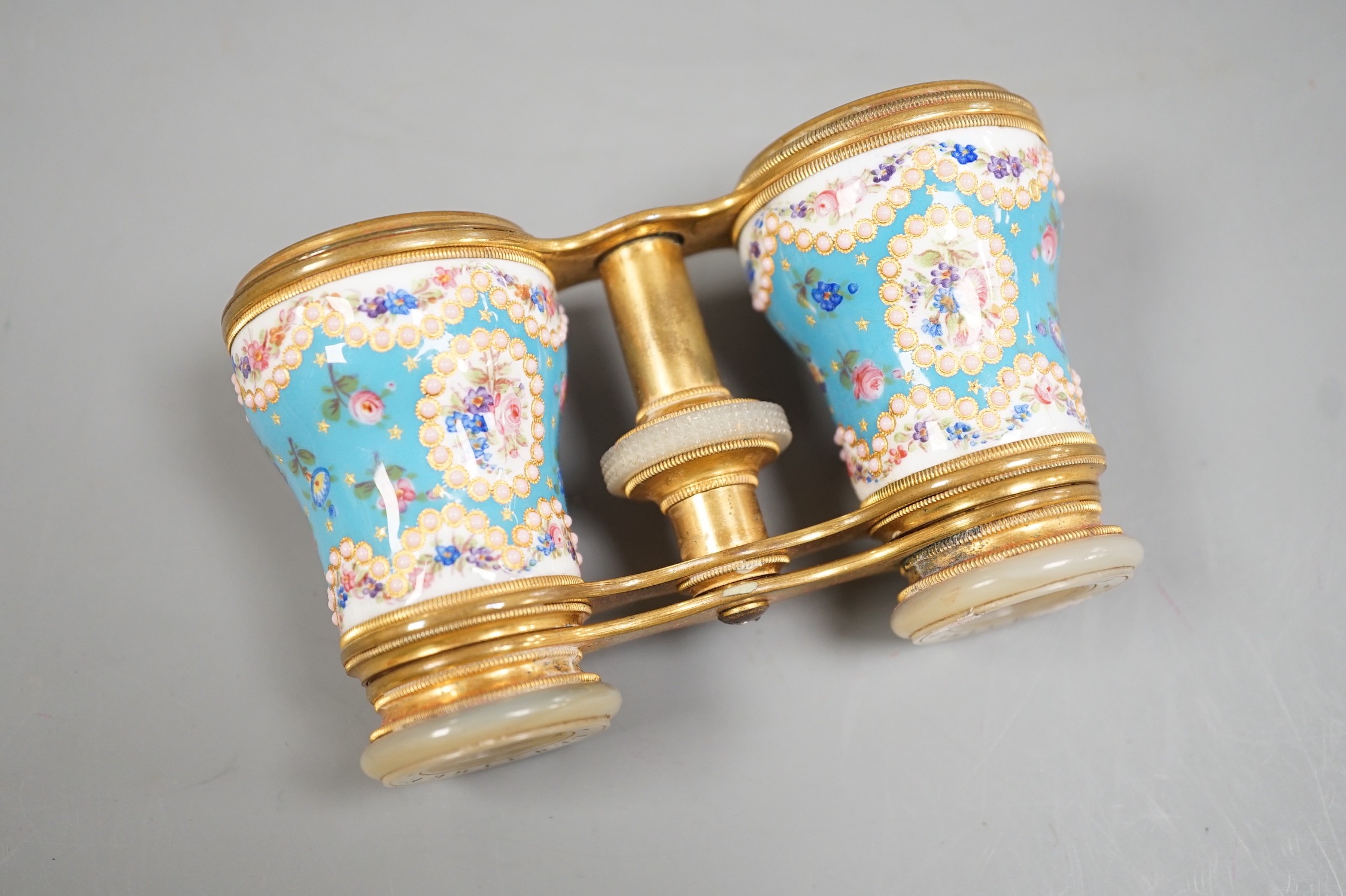 A pair of French enamel, brass and mother of pearl opera glasses, signed ‘Le Maire Paris’, in original fitted case